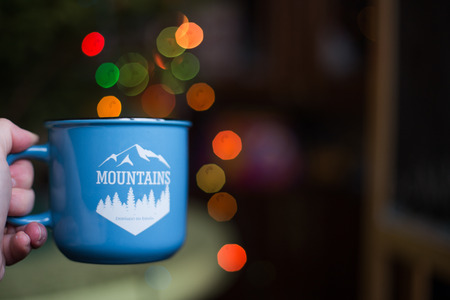 a cup in the hand . Christmas bokehの写真素材