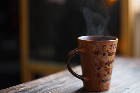 hot drink in a mug with steam on a dark backgroundの写真素材