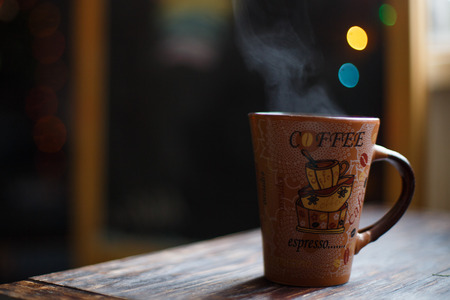 a cup  on the wooden background . Christmas bokehの写真素材