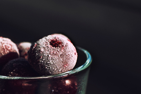 frozen cherry  close in a glass on a dark backgroundの写真素材