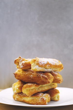 eclairs cakes lie on a white plate.  sweet cakes eclairsの写真素材