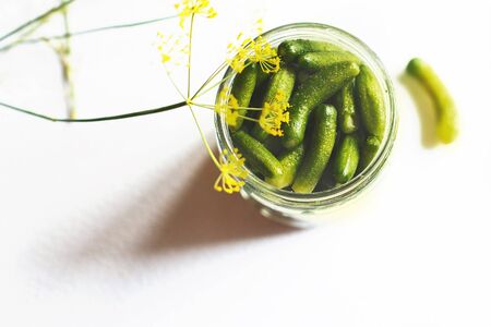 jar with pickled cucumbers on a white background. gherkins cucumbers.の写真素材