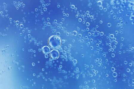 abstract light blue background with oil circles .  bubbles of water close up . oil bubbles in the water macro.  circle bubbles  backgroundの写真素材