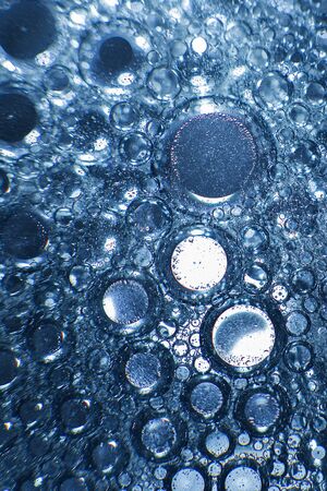 abstract light blue background with oil circles .  bubbles of water close up . oil bubbles in the water macro.  circle bubbles  backgroundの写真素材