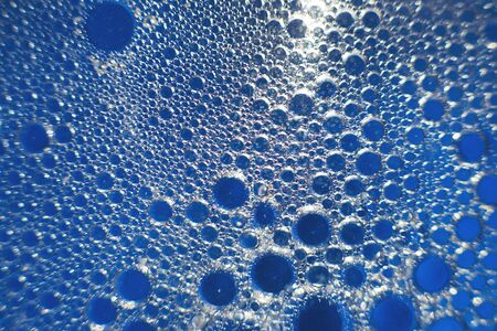 abstract light blue background with oil circles .  bubbles of water close up . oil bubbles in the...