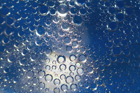 abstract light blue background with oil circles .  bubbles of water close up . oil bubbles in the water macro.  circle bubbles  backgroundの写真素材