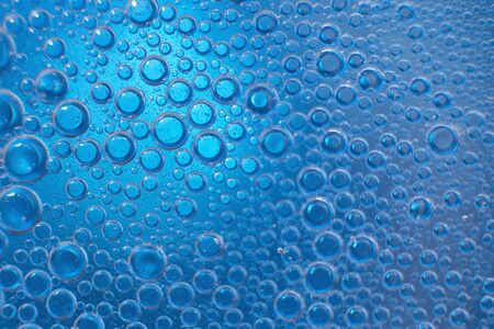 abstract light blue background with oil circles .  bubbles of water close up . oil bubbles in the water macro.  circle bubbles  backgroundの写真素材