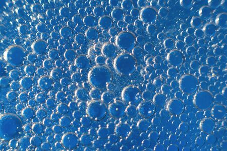 abstract light blue background with oil circles .  bubbles of water close up . oil bubbles in the water macro.  circle bubbles  backgroundの写真素材