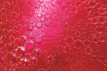 abstract light red background with oil circles .  bubbles of water close up . oil bubbles in the water macro.  circle bubbles  backgroundの写真素材