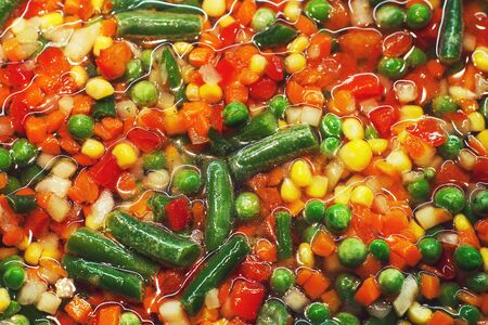 the vegetable mix  is fried in a pan on a white background . vegetable background closeの写真素材