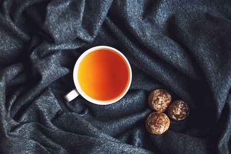 cup of hot tea with  gingerbread on a gray soft plaid close. Top viewの写真素材