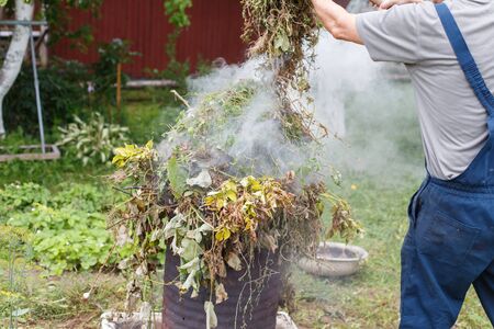 man firing grass in the gardenの写真素材