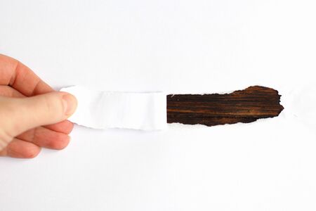 Hand tear a strip of white paper. place for textの写真素材