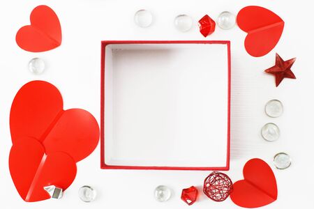 Open gift box with red hearts on a white background, concept of Valentine's, anniversary, mother's day and birthday greeting. copyspace, topview.の写真素材