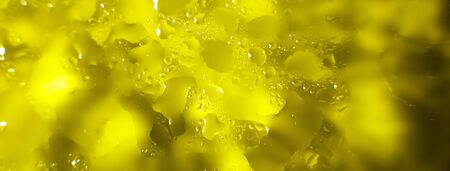 water drops on a yellow background. Abstract yellow background. Water drops on glass. bannerの写真素材