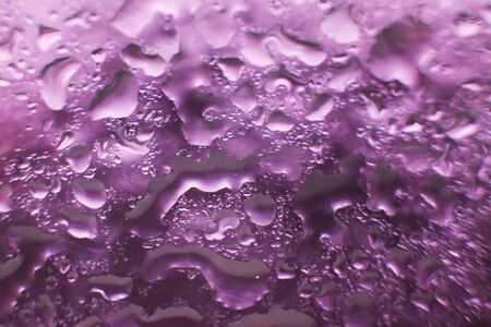 water drops on a purple background. Abstract purple background. Water drops on glass.の写真素材