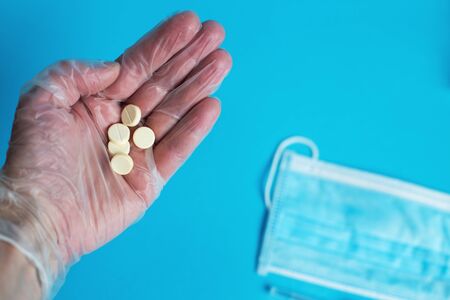 medical mask, syringe and tablets close on the blue background. Coronavirus, flu, respiratory disease concept. Horizontal orientation. Top view.の写真素材