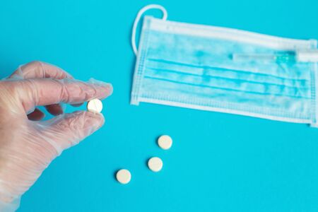 medical mask, syringe and tablets close on the blue background. Coronavirus, flu, respiratory disease concept. Horizontal orientation. Top view.の写真素材