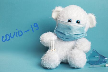 big teddy bear are sitting in white medical masks on a blue background. Respiratory medicine.の写真素材