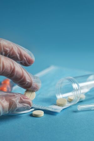 medical mask, syringe and tablets close on the blue background. Coronavirus, flu, respiratory disease concept. Horizontal orientation. Top view.の写真素材