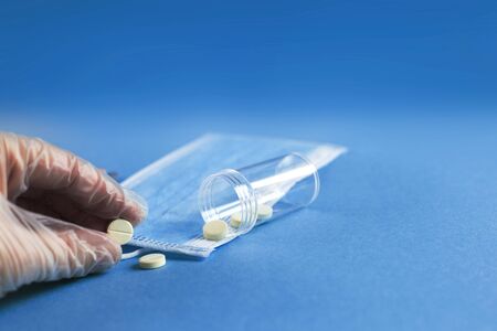 medical mask, syringe and tablets close on the blue background. Coronavirus, flu, respiratory disease concept. Horizontal orientation. Top view.の写真素材
