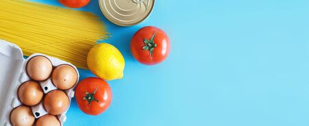 Different healthy food products on a blue background. Top view. fruit, vegetable, eggs and grocery online shop. Bannerの写真素材