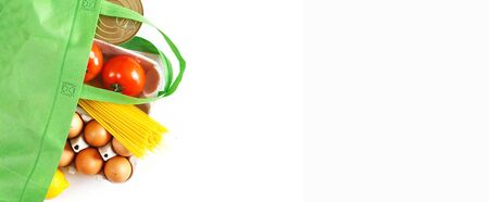 Full green bag of healthy food on a white background. Top view. fruit, vegetable, eggs online shop. your text. food deliveryの写真素材