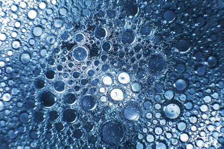 abstract light blue background with oil circles .  bubbles of water close up . oil bubbles in the water macro.  circle bubbles  backgroundの写真素材