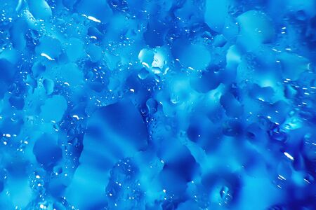 water drops on a blue background. Abstract blue background. Water drops on glass. Natural background...