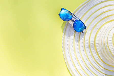 Travel vacation background. Sun glasses yellow background. Concept summer holidays.の写真素材