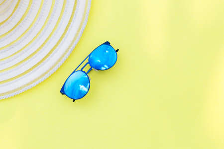 Travel vacation background. Sun glasses yellow background. Concept summer holidays.の写真素材