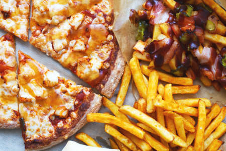Unhealthy concept. Fast Food - Pizza, Fried Potato. Close up. Popular fast food recipesの写真素材