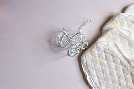 Baby diapers with toy carriage on a white background