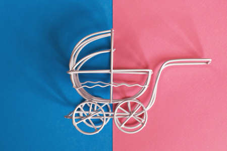 vintage baby stroller on pink and blue background. Boy or girl questionの写真素材