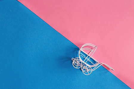 vintage baby stroller on pink and blue background. Boy or girl questionの写真素材