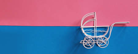 vintage baby stroller on pink and blue background. Boy or girl questionの写真素材