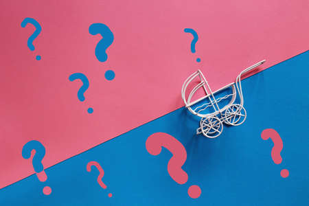 vintage baby stroller on pink and blue background. Boy or girl questionの写真素材