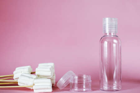spa cosmetic products with sweets, transparent tube, branding mockup on a pink background. Plastic...
