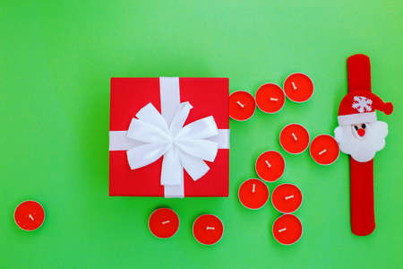 Christmas composition. Christmas gift, presrnt box and many red candles Top view, flat lay.の写真素材