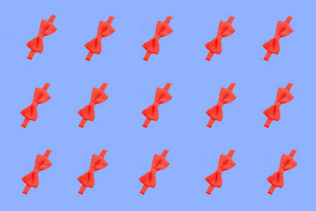 red bow pattern. red bow on a blue background.の写真素材