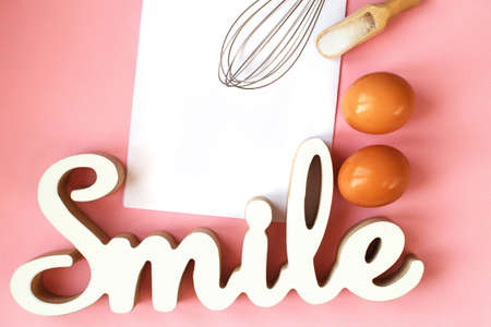 Ingredients for cooking baking - egg, sugar, rolling pin on pink background. Concept of cooking dessert and sweet foodの写真素材