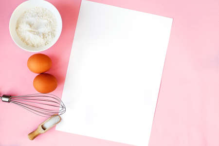 Ingredients for cooking baking - flour, egg, sugar, rolling pin on a pink background. Concept of...