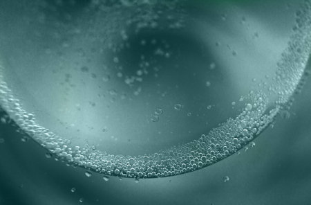 abstract green background with oil circles. water drops close up. oil bubbles in the water macro. circle bubbles backgroundの写真素材