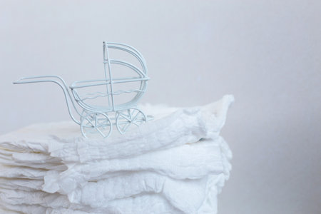 Baby diapers with a toy carriage on a white background