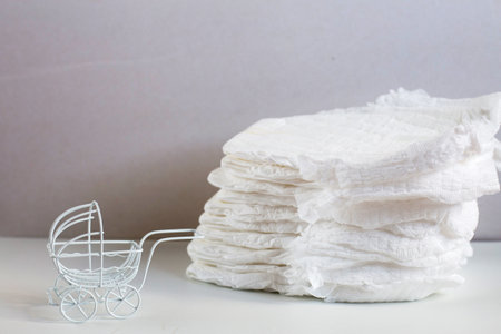 Baby diapers with a toy carriage on a white background