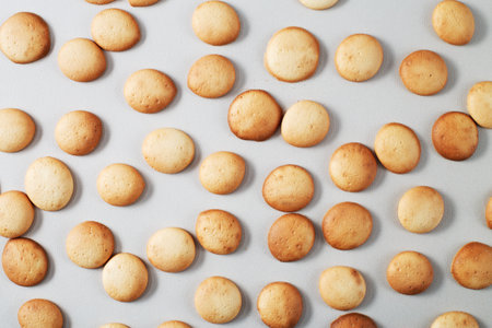 A pattern of a small pancakes. Background from orange toasted round biscuits. home bakeryの写真素材