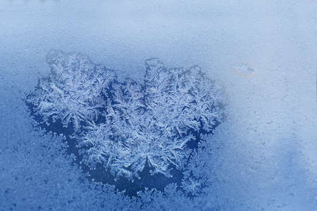 snow pattern on the glass from frost. pattern of snowflakes on the windowの写真素材