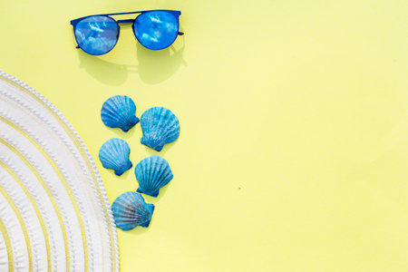 Travel vacation background. Sun glasses sea shells bright yellow background. Concept summer...