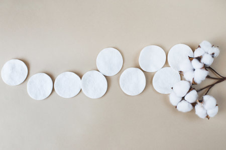 fluffy cotton flower cotton pads on a beige background with copy space. hygienic disposable productの写真素材