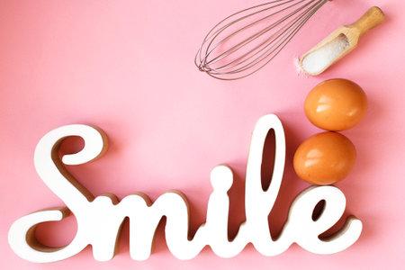 Ingredients for cooking baking - egg, sugar, rolling pin on pink background. Concept of cooking dessert and sweet foodの写真素材